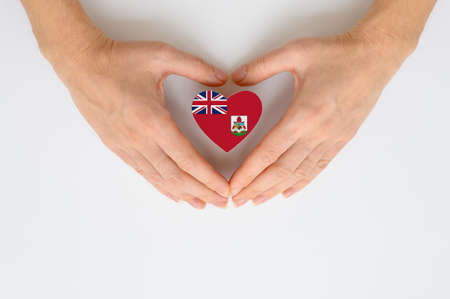 The national flag of Bermuda in female hands.の写真素材