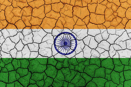 India flag on dry cracked ground. Abnormal drought concept indiaの写真素材