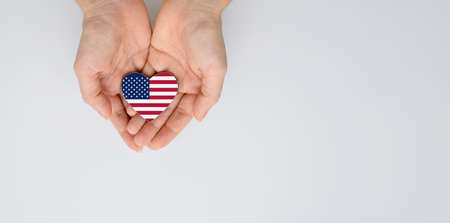 The national flag of the United States of arms in female hands. Flat lay, copy space.の写真素材