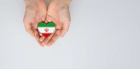 The national flag of Iran of arms in female hands. Flat lay, copy space.の写真素材