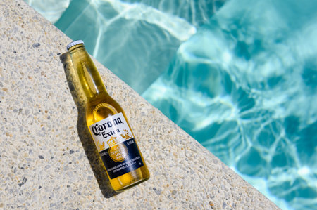 Novorossiysk - Russia, July 2022: A cold bottle of Corona Extra beer lies by the pool on a hot summer day.のeditorial素材