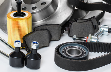 car repair concept. New spare parts on a light background. Selective focus on the brake pads in the center of the frame.の写真素材