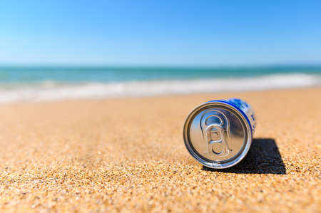 Can of cold refreshing drink on the sandy shore.の写真素材