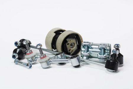 Car spare parts for running suspension repair on a white background.