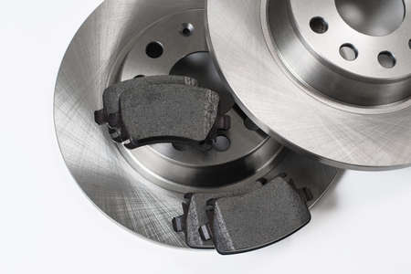 Brake pads on brake discs. New spare parts for repairing brakes on a white background. view from above.の写真素材