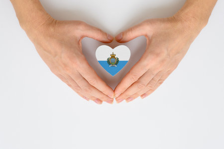 The national flag of the Republic of San Marino in female hands.の写真素材