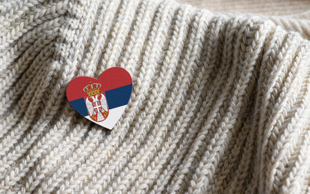 Flag of the Serbia in the shape of a heart on warm woolen things. The concept of winter in Serbia.の写真素材