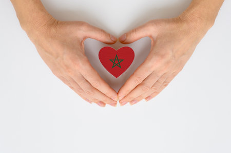 The national flag of Morocco in female hands.の写真素材