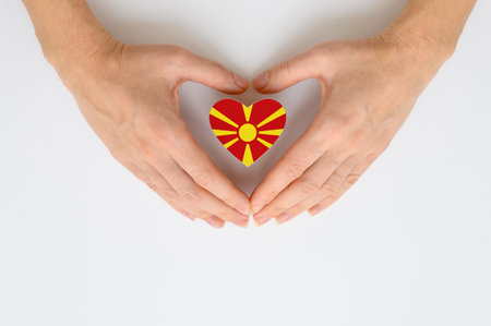 The national flag of a Macedonia in female hands.の写真素材