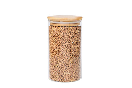 Glass jar with buckwheat on a white isolated background.の写真素材
