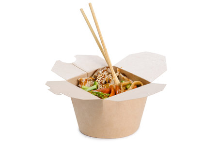 Wok in a paper container with chopsticks on a white background. Chinese noodles.の写真素材