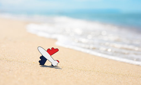 Vacation on the coast of France. Airplane in the colors of the flag of France on the seashoreの写真素材