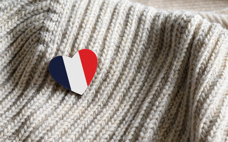 Flag of the France in the shape of a heart on warm woolen things.の写真素材