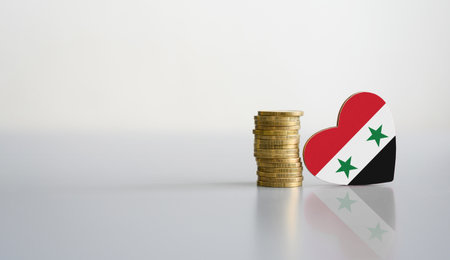 A stack of coins and the flag of Syria in the shape of a heart. The concept of donations and financial assistance to Syria.の写真素材