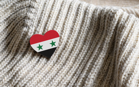 Flag of the Syria in the shape of a heart on warm woolen things.の写真素材
