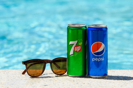 Novorossiysk - Russia, July 2022: Cans of Pepsi Cola and 7up and sunglasses by the pool on a summer day. summer vacation conceptのeditorial素材