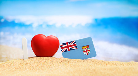I love Fiji. Flag of Fiji on the beach with a red heart. vacation and travel concept.の写真素材