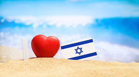 I love Israel. Flag of Israel on the beach with a red heart. vacation and travel concept.の写真素材