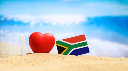 I love South Africa. Flag of South Africa on the beach with a red heart. vacation and travel concept.の写真素材