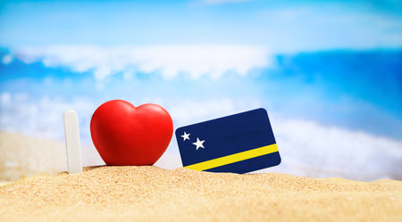 I love Curacao. Flag of Curacao on the beach with a red heart. vacation and travel concept.の写真素材