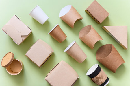 The concept of the production of eco-friendly dishes for fast food. Set of packaging for food on a green background.の写真素材