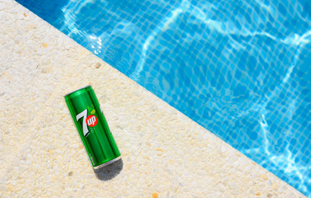 Anapa, Russia - July 2023: Drink 7up on the edge of the pool on a hot sunny day.