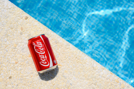 Anapa, Russia - 18 July 2023: Drink Coca Cola on the edge of the pool on a hot sunny day. close-upのeditorial素材