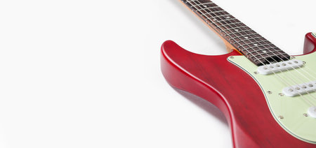 Part of an electric guitar on a white background. Free space. Selective focus on the fretboard.の写真素材