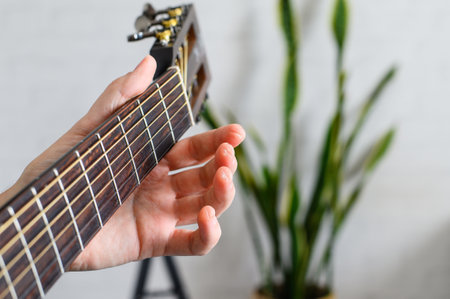 Close-up of guitarist's hand. Calluses on guitarist's fingers. Selective focusの写真素材
