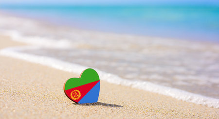 Flag of Eritrea in the shape of a heart on a sandy beach.の写真素材