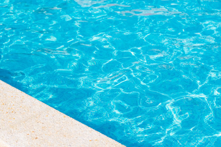Blue water of the pool. The edge of the pool. Free space. Selective focus on the edgeの写真素材