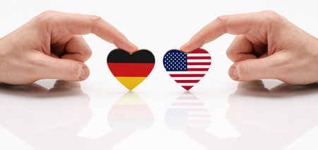 The concept of friendship and diplomatic relations between Germany and USA. The flag of Germany and US as a symbol of cooperation and respect.の写真素材