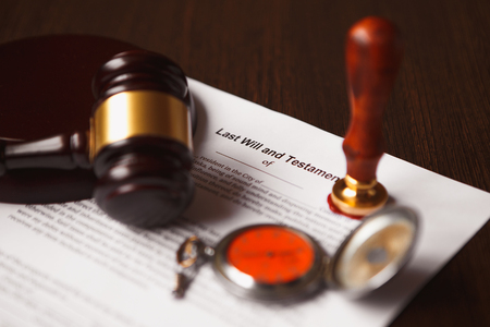 Closeup of male hand signing divorce papers.の写真素材
