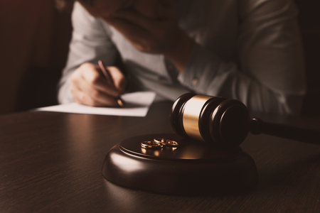Closeup of a man signing divorce papers.の写真素材