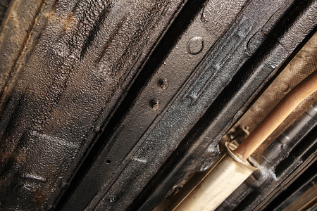 car mechanic cleaning car wheel brake disk from rust corrosion at automobile repair service stationの写真素材