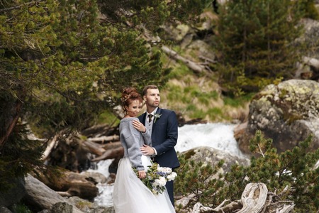 Wedding Beautiful couple sexy Bride dress young girl Brutal groom with beard and gray. Stylish man in costume on the nordic Kareの写真素材