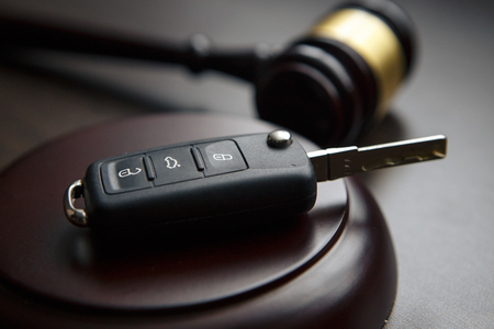 Car auction concept - gavel and car key on the wooden deskの写真素材