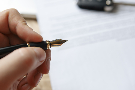 signing pen and car key for Vehicle Sales Agreementの写真素材