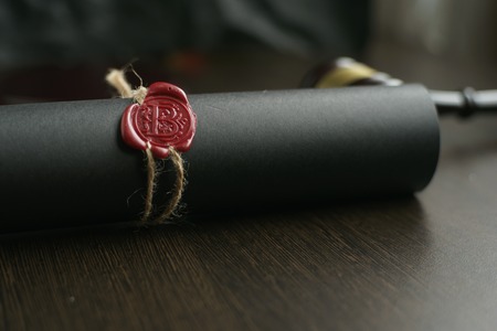 Metal wax notary public stamper on old document. Law officeの写真素材