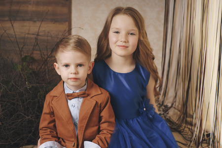 little cute boy girl hugging playing on white background, happy family close up brother and sister smilingの写真素材