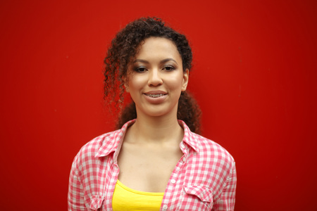 People and happiness concept. Cheerful African American young woman smiling at camera showing her...
