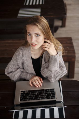 Happy hipster young woman working on laptop in the parkの写真素材
