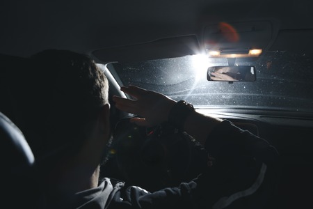 headlights of a car approaching in the darkの写真素材