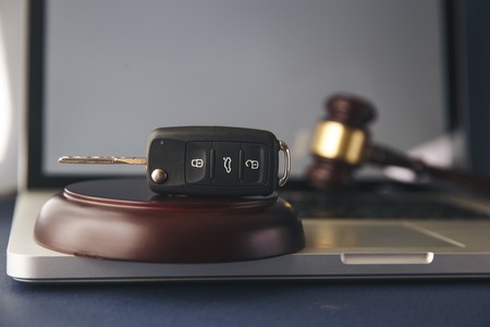 Car auction concept - gavel and car key on the wooden deskの写真素材