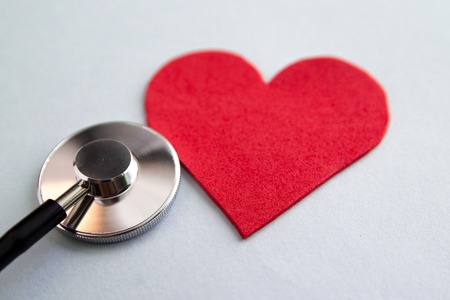 Healthcare medical insurance business and world heart health day concept with red heart and bandage...
