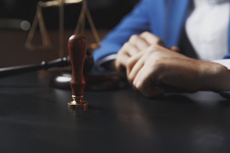 Notary signing a contract with fountain pen in dark room concept. pen business man law attorney lawyerの写真素材