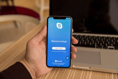 Tula, Russia - November 28, 2018: Hands using smart phone showing Skype signup page.Skype is a...