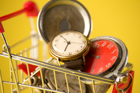 Shopping cart with clock.Time is money. Time is money concept a clockの写真素材