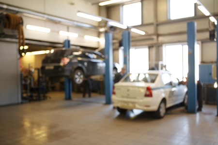auto repair service station blurred background. blurry cars on liftsの写真素材