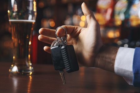 Do not drink and drive! Cropped image of drunk man talking carの写真素材